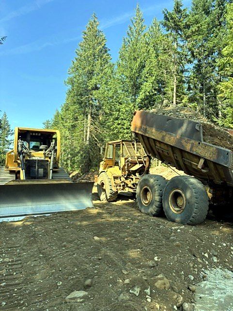 Dozer and articulated rock truck on an earthworks site