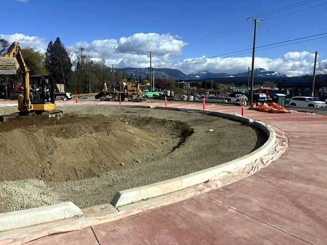Mini excavator shaping the centre of a new roundabout